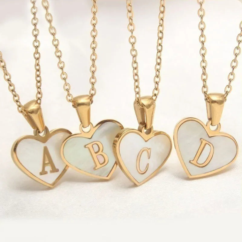Gold heart necklace with white shell pendant and initial charm on 45cm adjustable chain