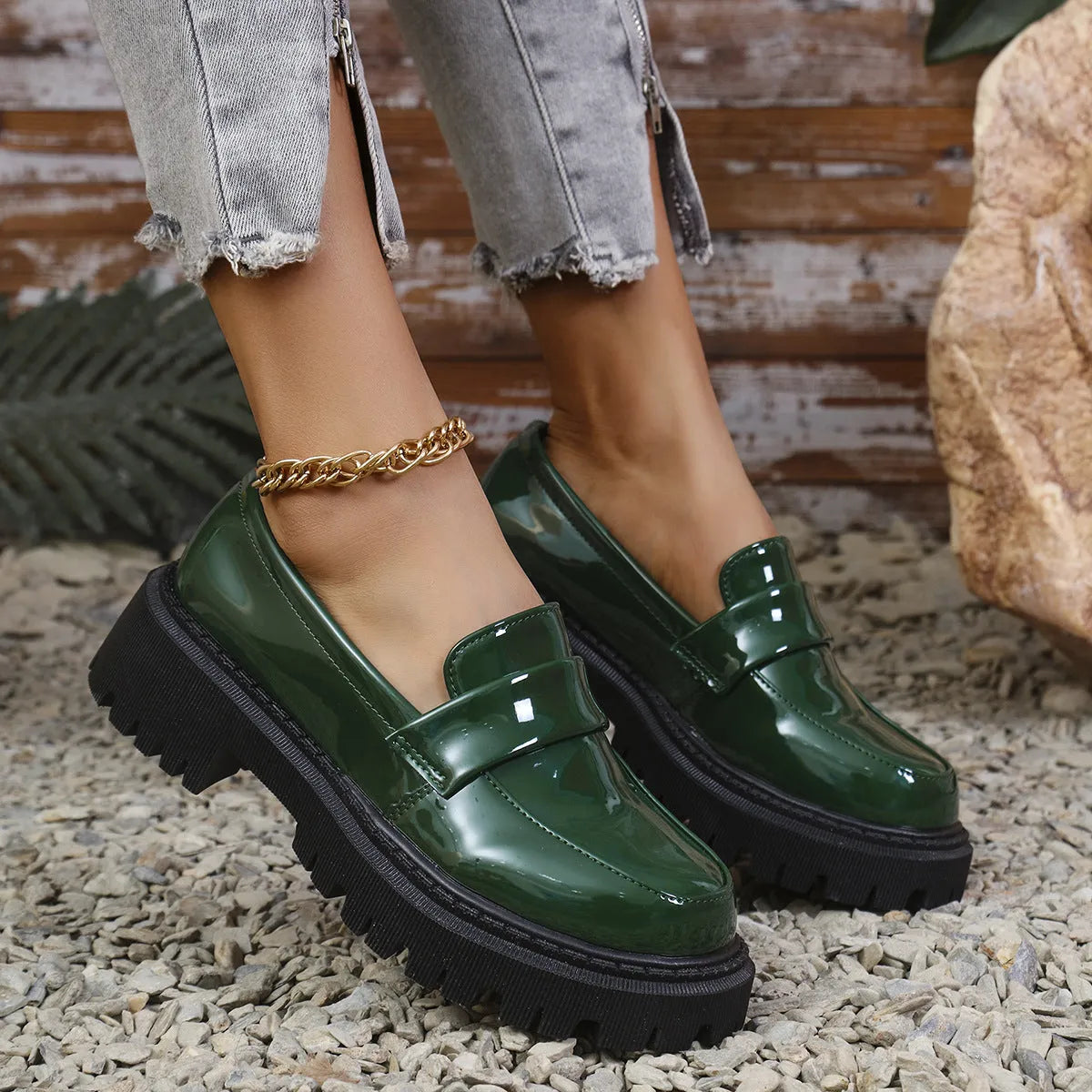 Plus size black slip-on loafers with chunky platform heel on a solid colour background