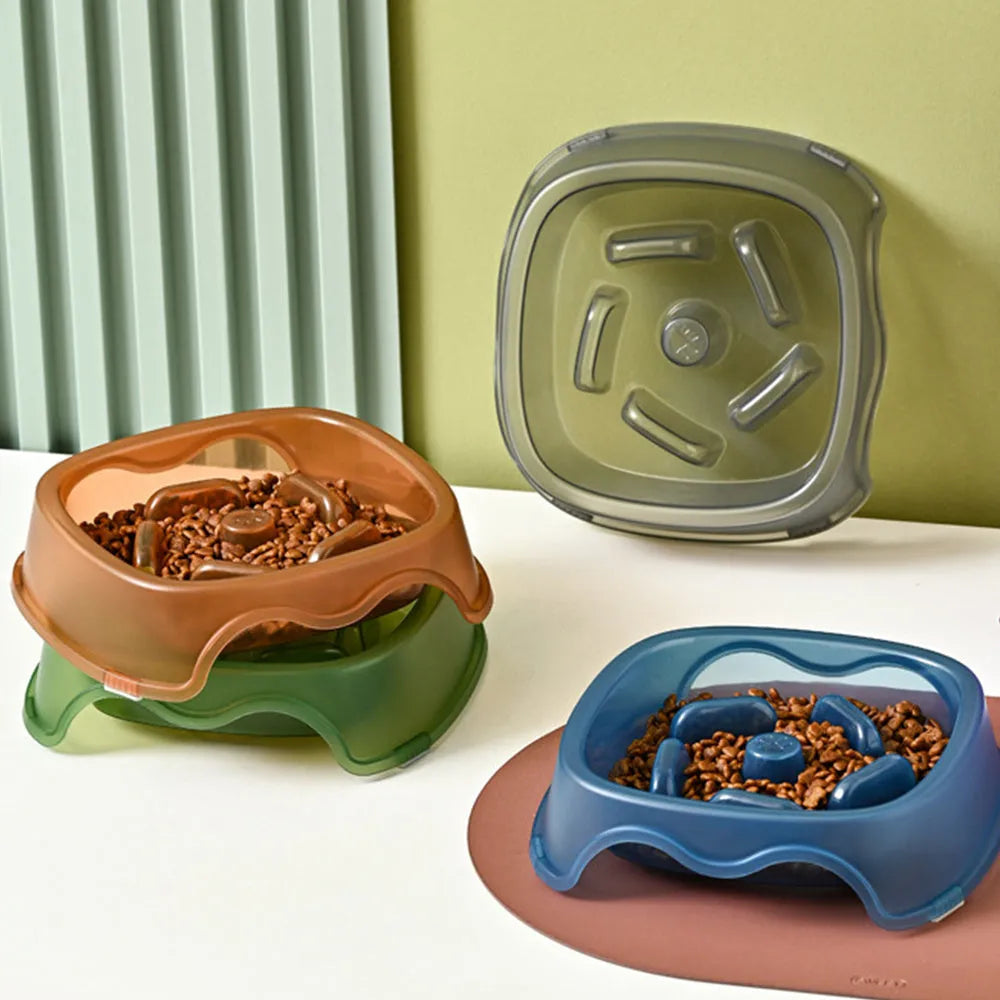 Blue plastic slow feeder dog bowl with anti-choking design on a white surface.