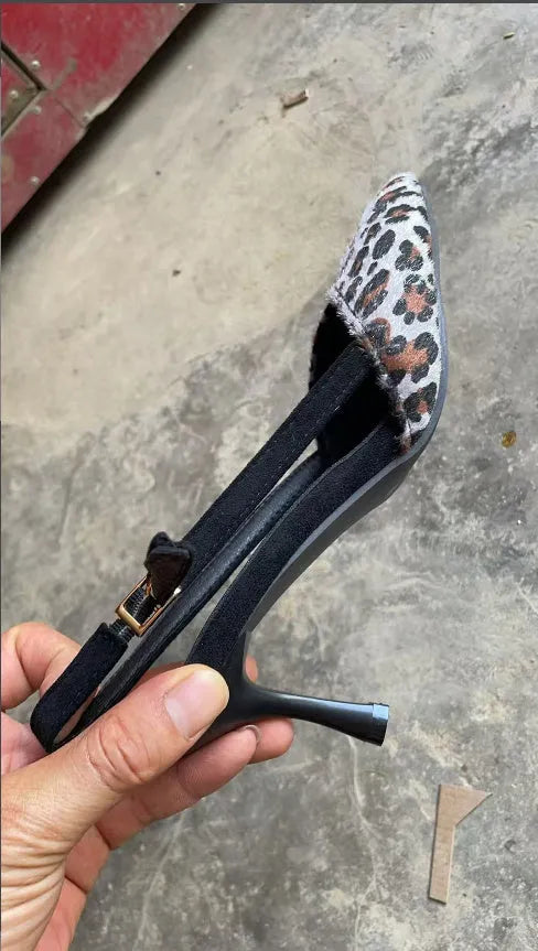Women's leopard print suede high heel sandals with a pointed toe on a white background.