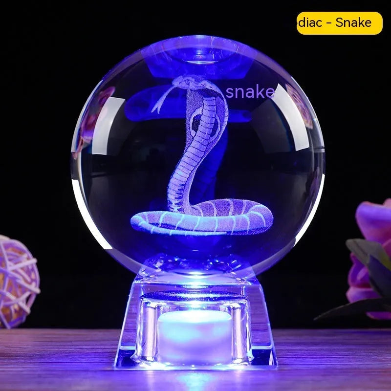 White crystal ball luminous ornament with Chinese zodiac animal design on an electronic charging base.