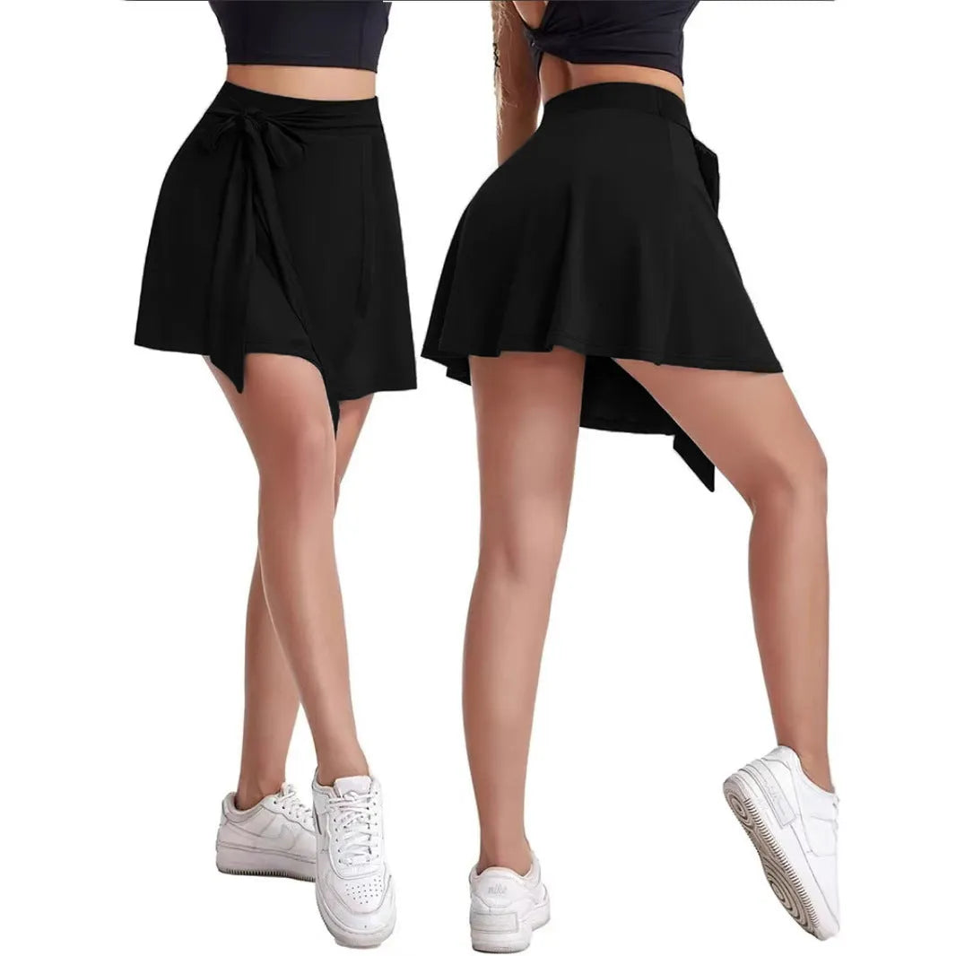 Black thigh-length sports skirt with built-in shorts, elastic high waist, and shoulder strap