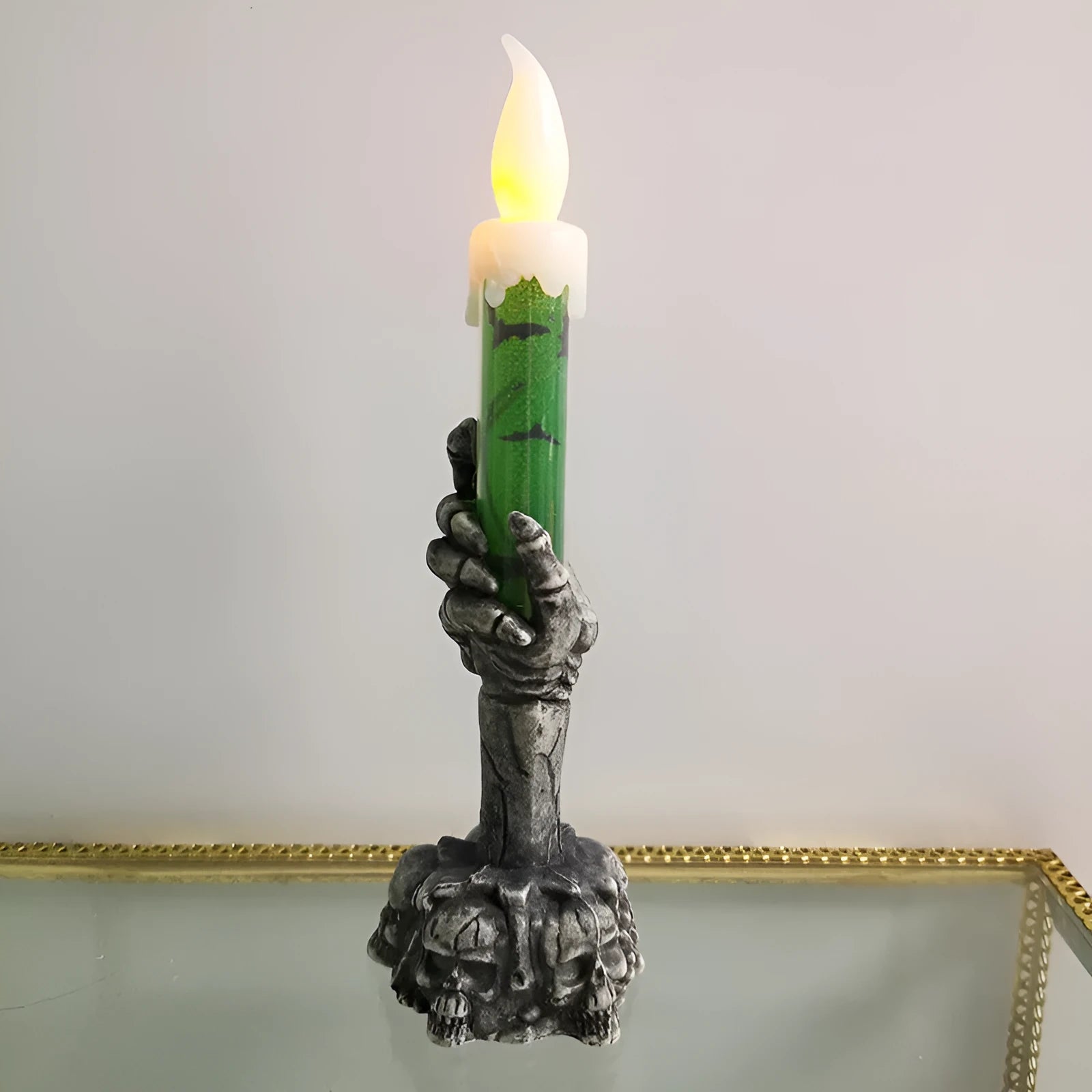 Plastic skeleton ghost holding a candle light Halloween decoration in orange and green