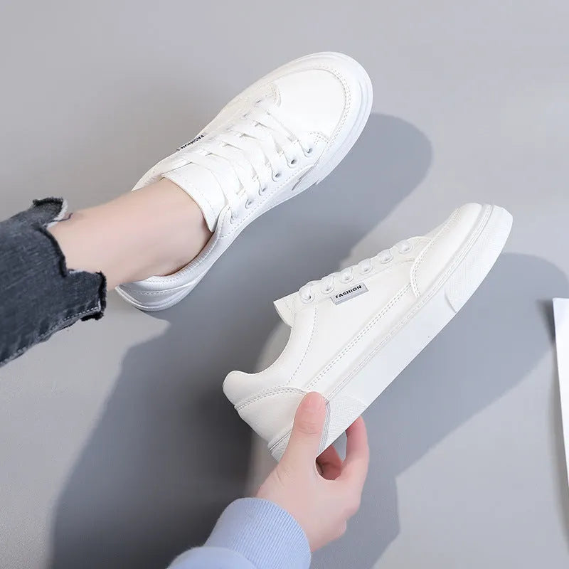 Korean style white and brown low-top women's sneakers on a solid background.