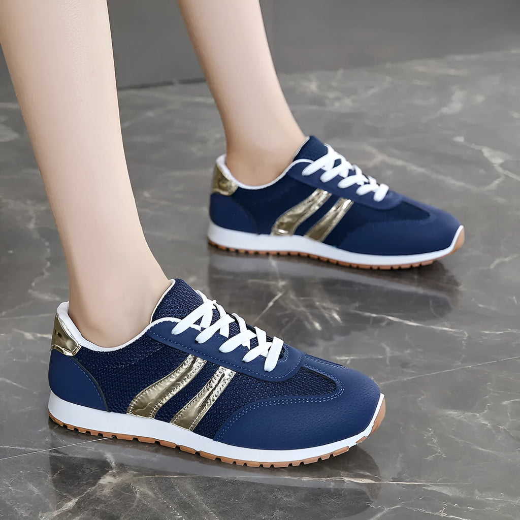 Blue women's casual tennis shoes with cross shoulder straps and a flat rubber sole