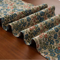 Nordic jacquard bouquet pattern table runner with striped design and decorative tassel fringe in dark blue