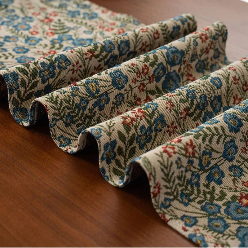 Nordic jacquard bouquet pattern table runner with striped design and decorative tassel fringe in dark blue