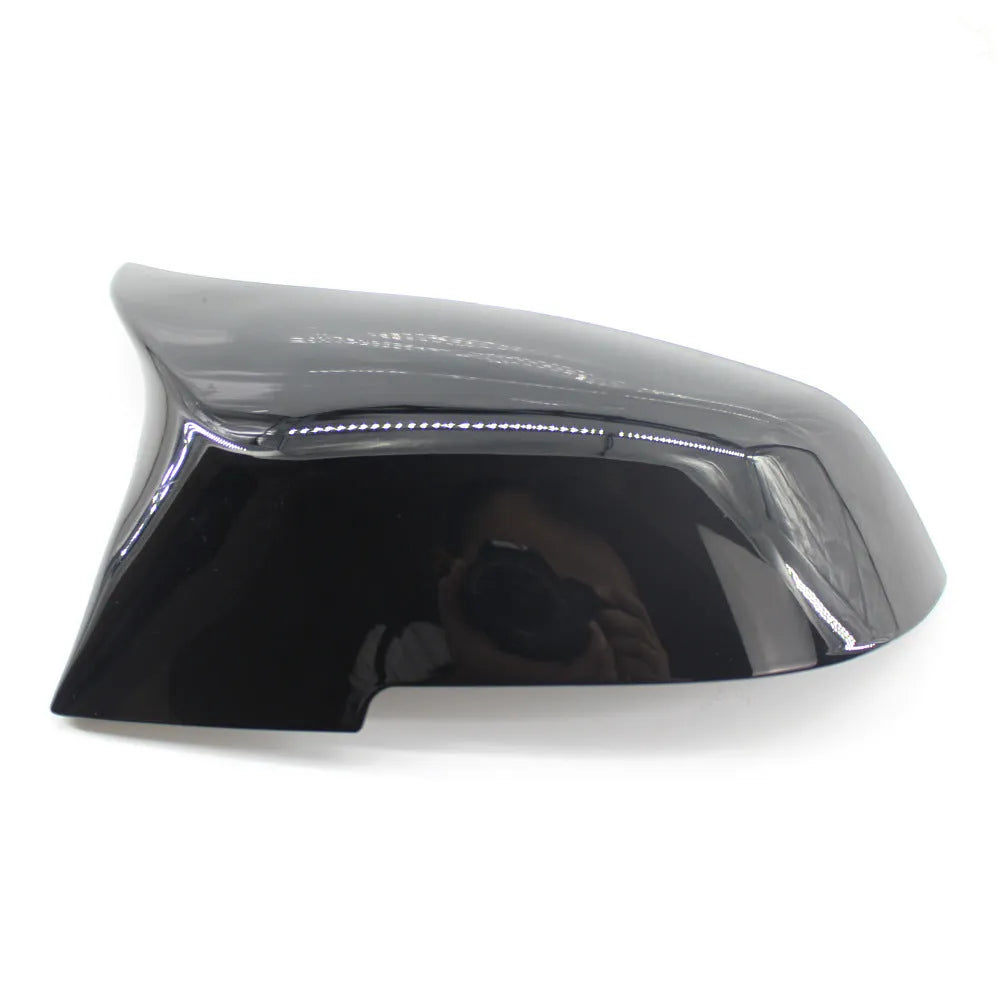 Pair of dark bright black BMW horn-style rear-view mirror replacement shells.