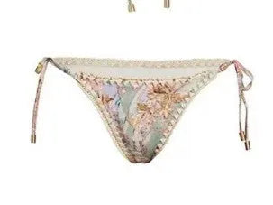 Creamy-white women's floral print bikini set with matching skirt on a hanger.
