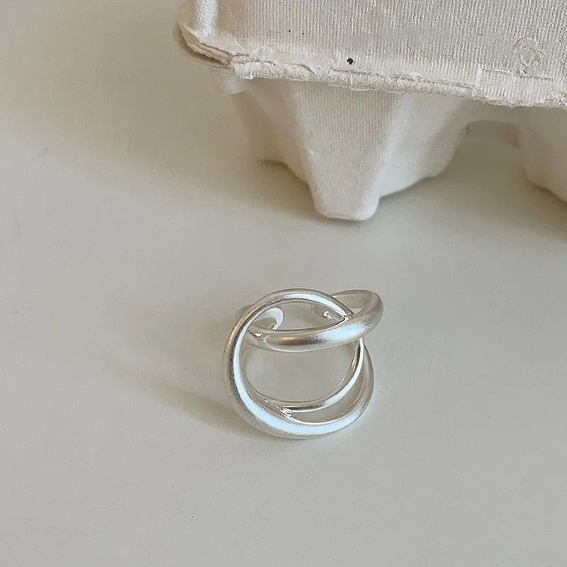 Three-dimensional interlaced geometric open ring in matte metal with gold plating
