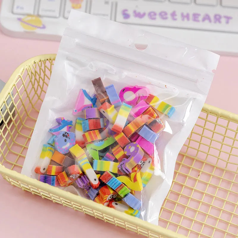 Assortment of fifty small cartoon-shaped rubber erasers in fruit and animal designs.
