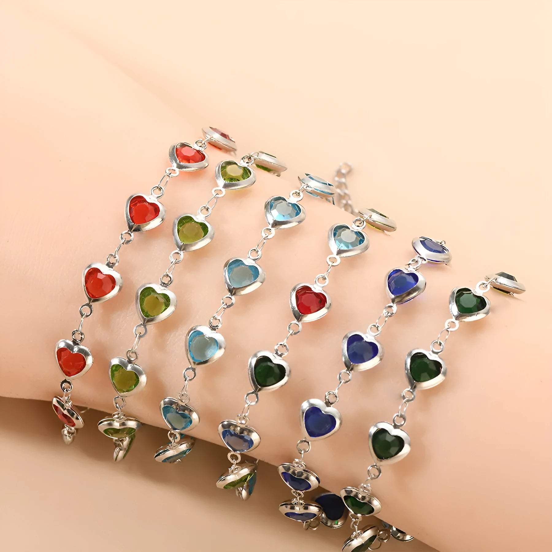 Stainless steel heart-shaped bracelet with electroplated geometric design in various colours like red, blue, and green for unisex wear.