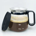 Transparent borosilicate glass coffee jug with black silicone cover on a kitchen counter