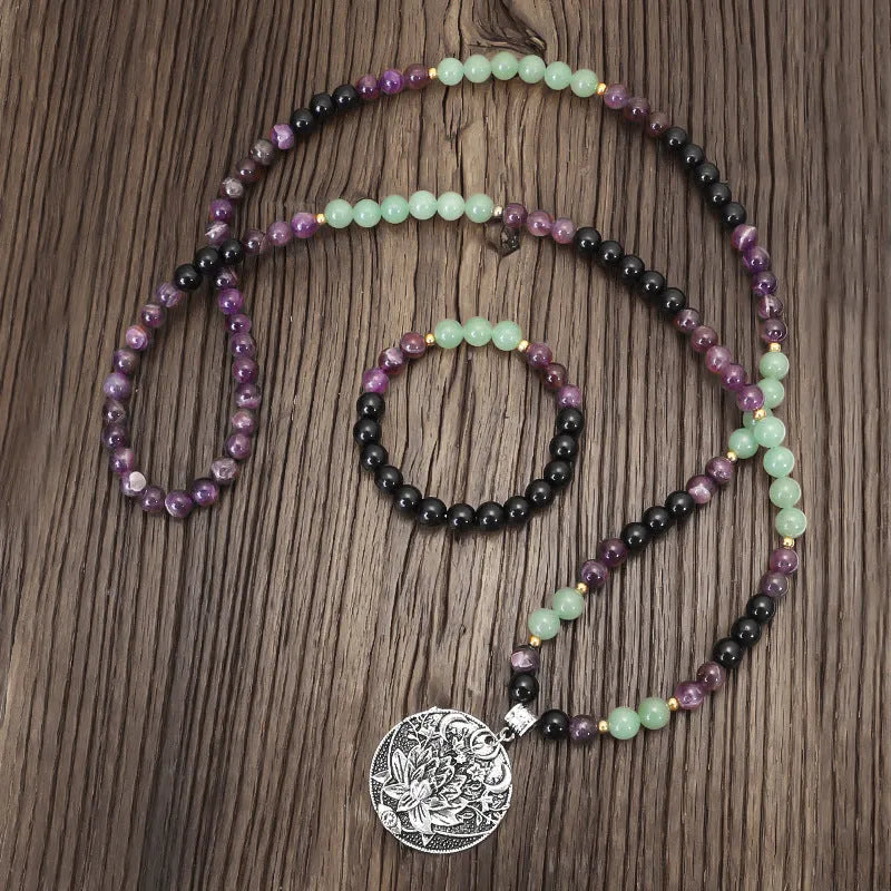 Yoga necklace with geometric lotus pendant and stone bead chain alongside a matching bracelet