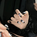 Black pink heart shape hand-painted false nails with bow designs in plastic armour suit
