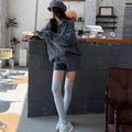 Ladies' creamy-white cable knit sweater and shorts set on a hanger.