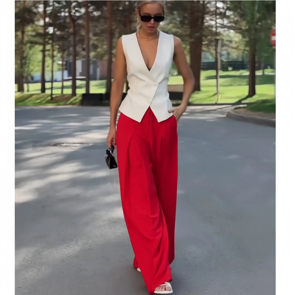 Women's beige two-piece set featuring a sleeveless deep V-neck top and high-waist wide-leg trousers.