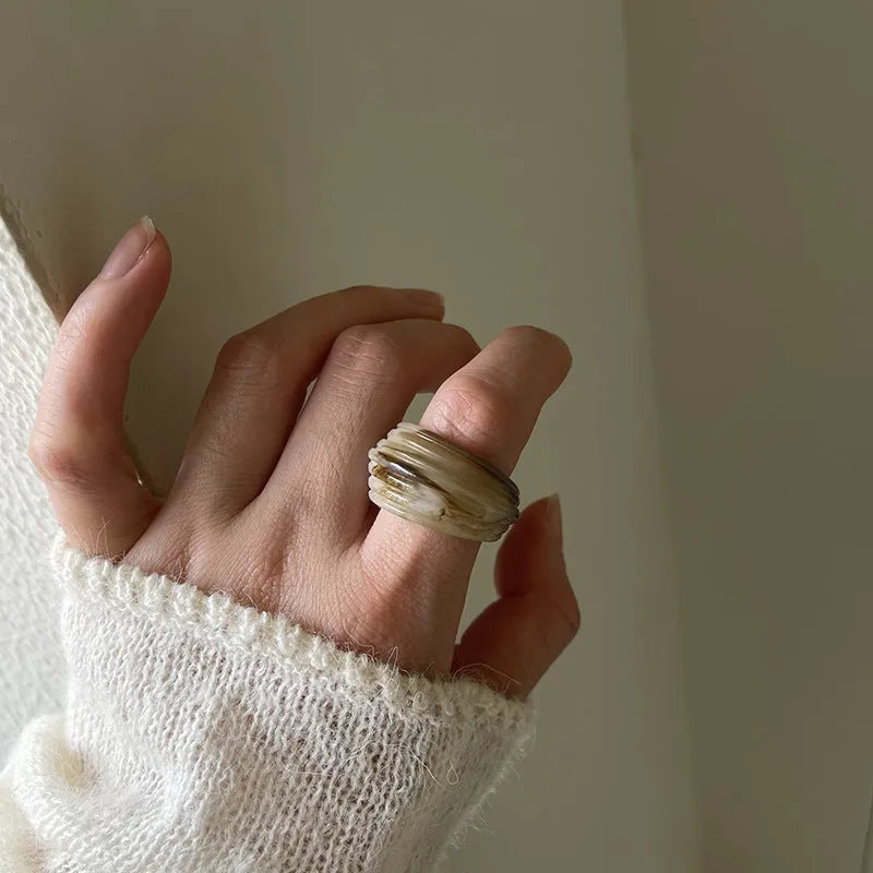 Chinese style resin ring with geometry shape and irregular width in brown or white.