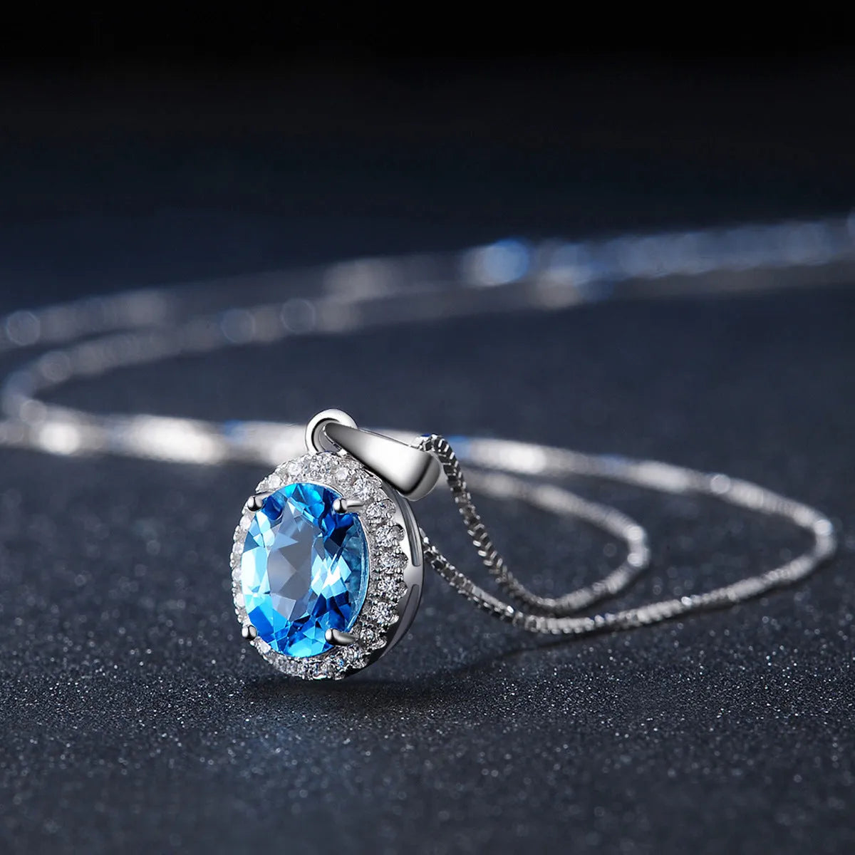 925 sterling silver jewellery set with blue topaz gems showing geometric patterned necklace, earrings, ring and pendant