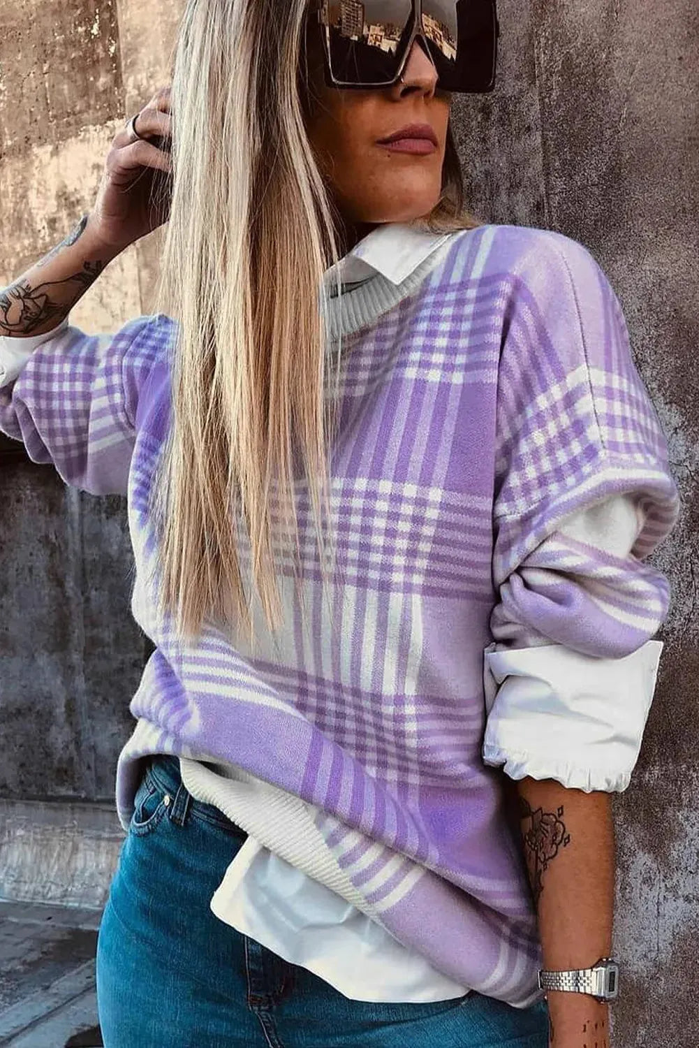 Lilac plaid print loose long sleeve sweater with ribbed cuffs and hem on a hanger.