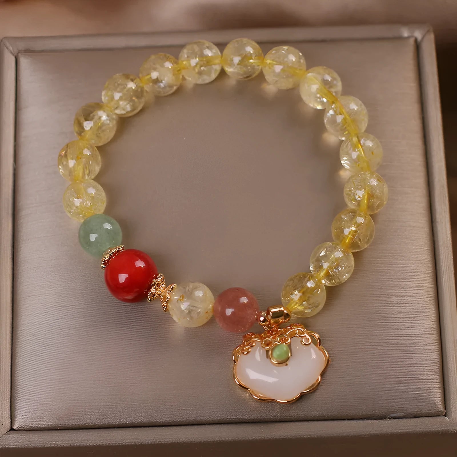 Women's alloy bracelet with a yellow citrine jade ruyi pendant charm.
