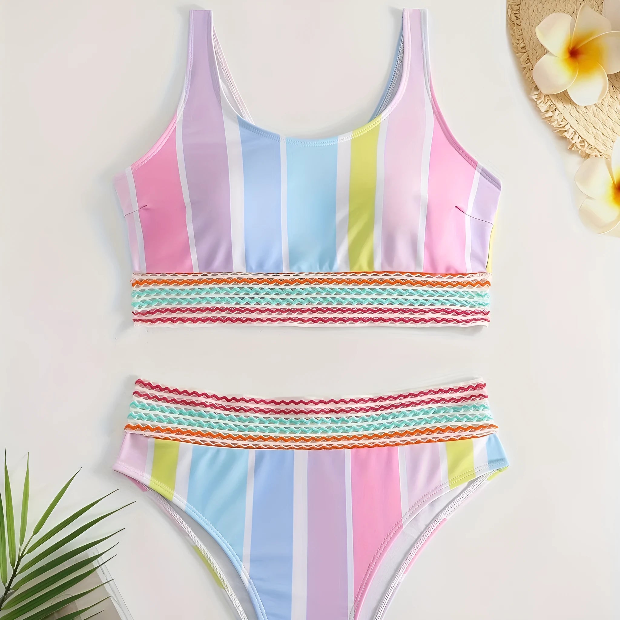 Women's striped two-piece bikini set for swimming and sports on a neutral background.