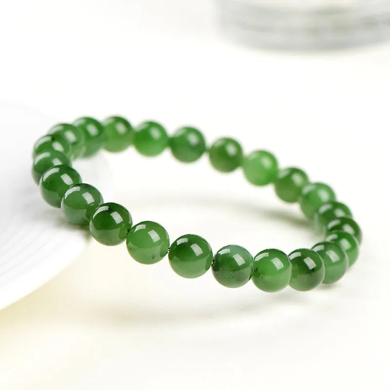 Polished Hetian jade bead bracelet in jasper colours, shown in various bead sizes on a wrist.