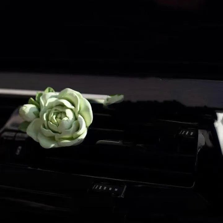Solid gypsum car vent air freshener in jasmine fragrance, showing off-white or green colour.