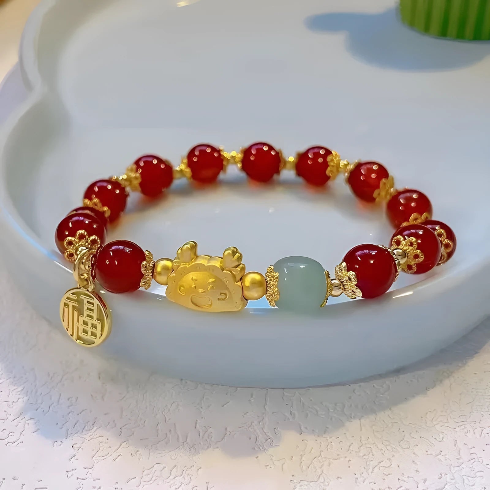 Women's floral glazed bracelet with zodiac animal charm and coloured glass beads in red, pink and white variations
