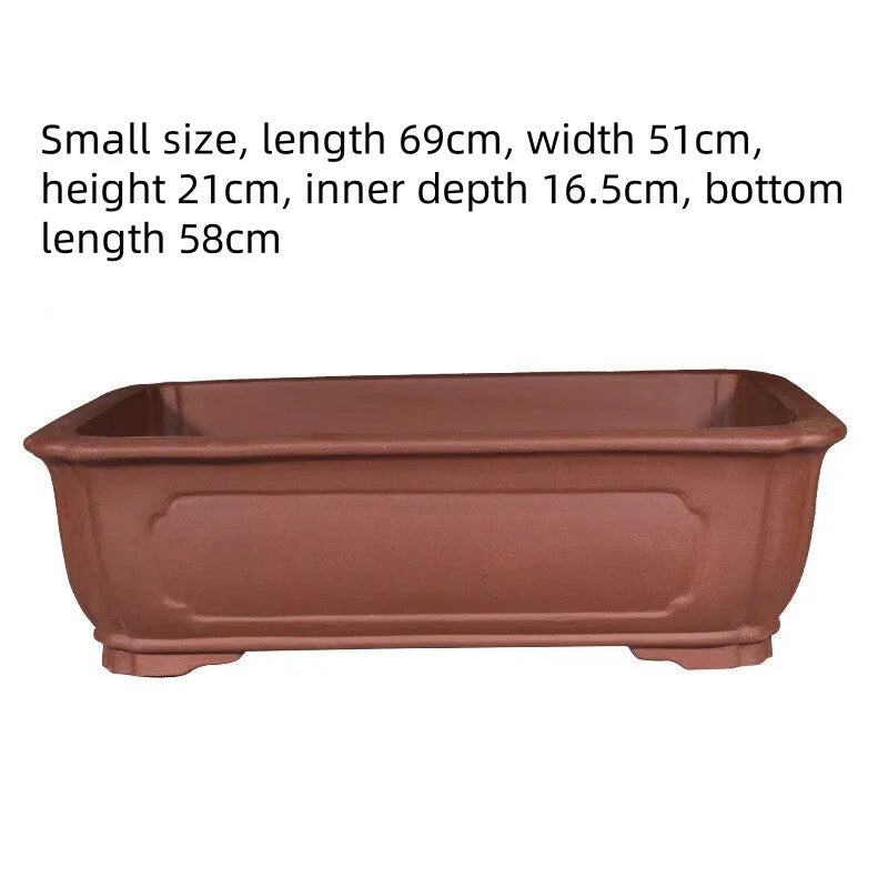 Large rectangular handmade purple clay bonsai flowerpot shown on a wooden surface.