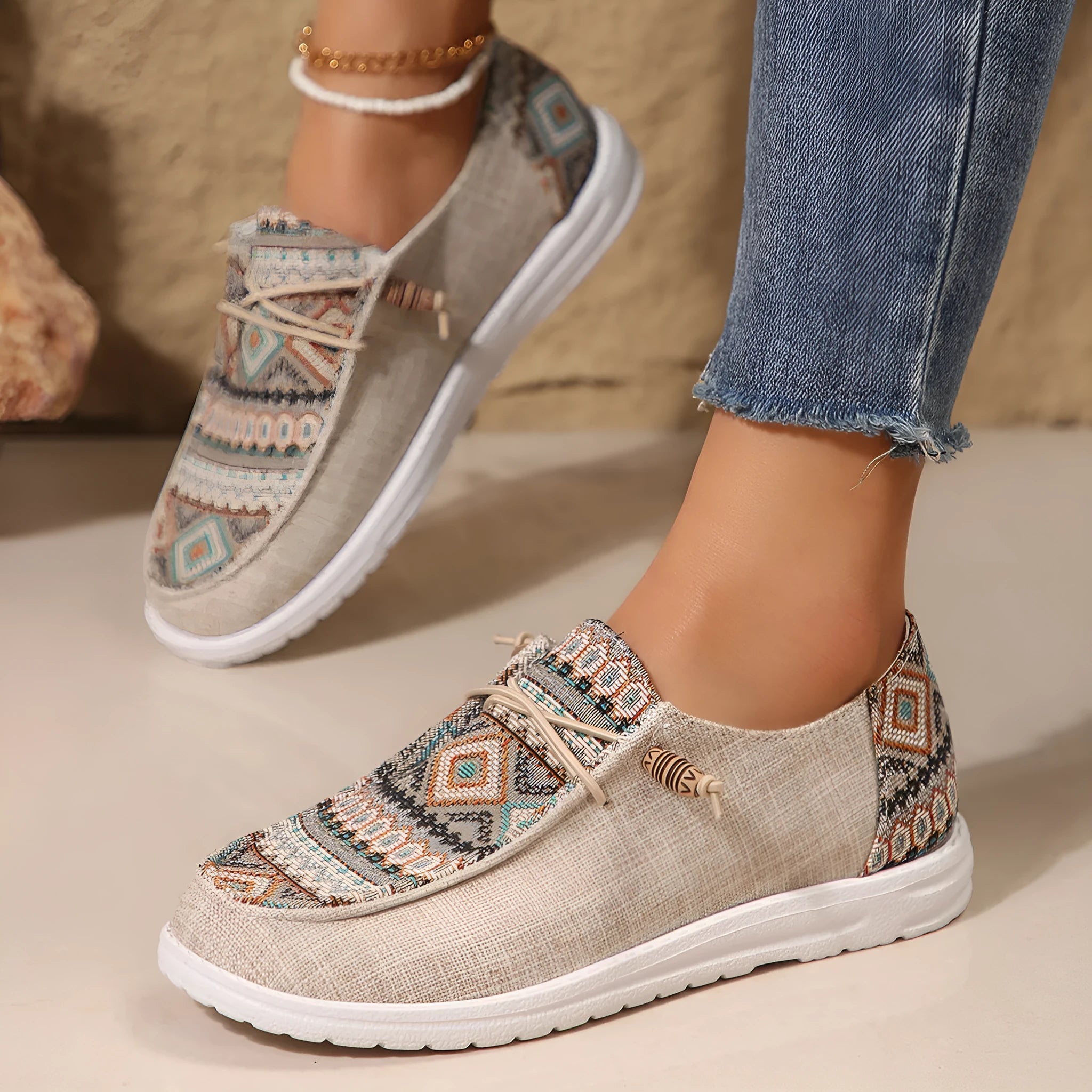 Women's black flat slip-on shoes with round toe and rubber sole on a neutral background.