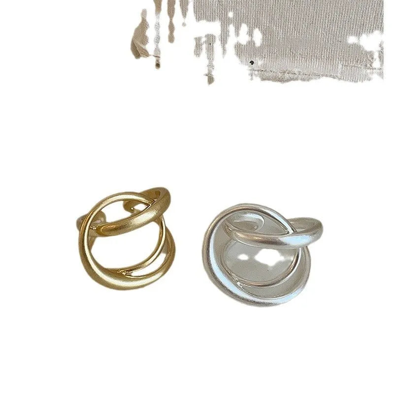 Three-dimensional interlaced geometric open ring in matte metal with gold plating