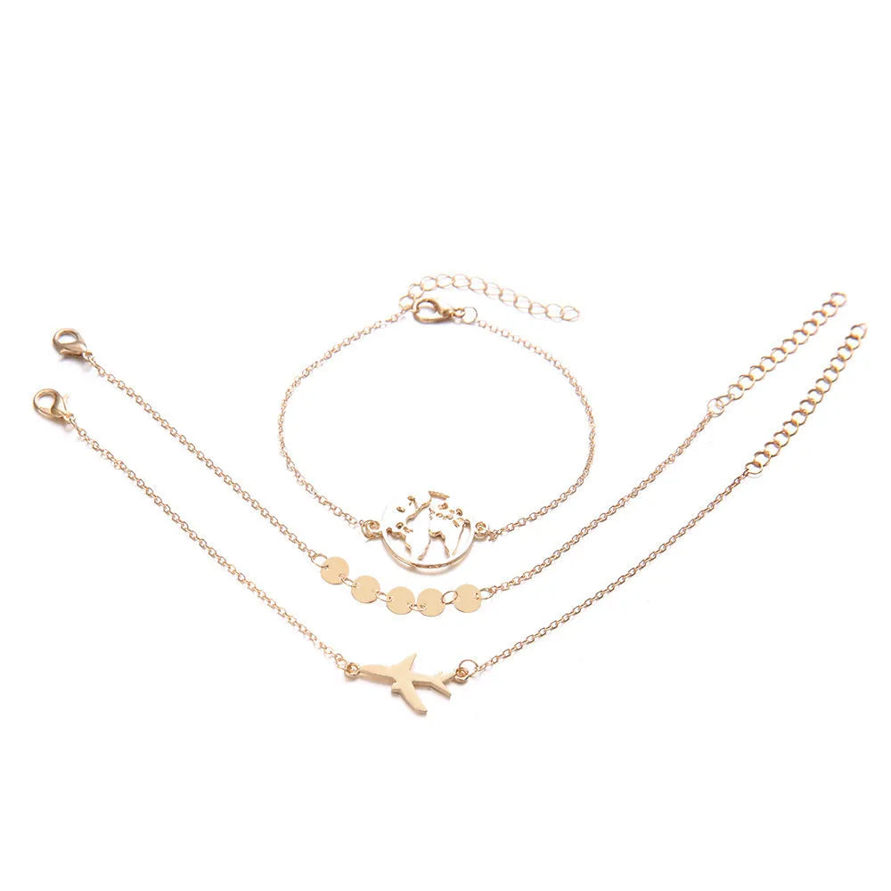 Three bohemian-style bracelets with heart-shaped aircraft map charms in electroplated alloy