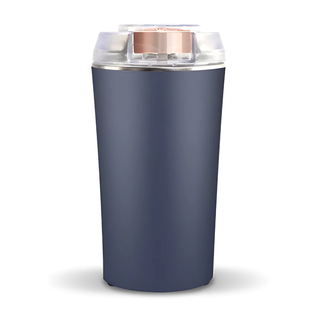 Compact blue mini flour mill and spice grinder made from stainless steel on a kitchen worktop.