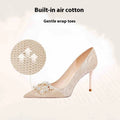 Champagne gold pointed-toe stiletto high heels with rhinestone decoration.