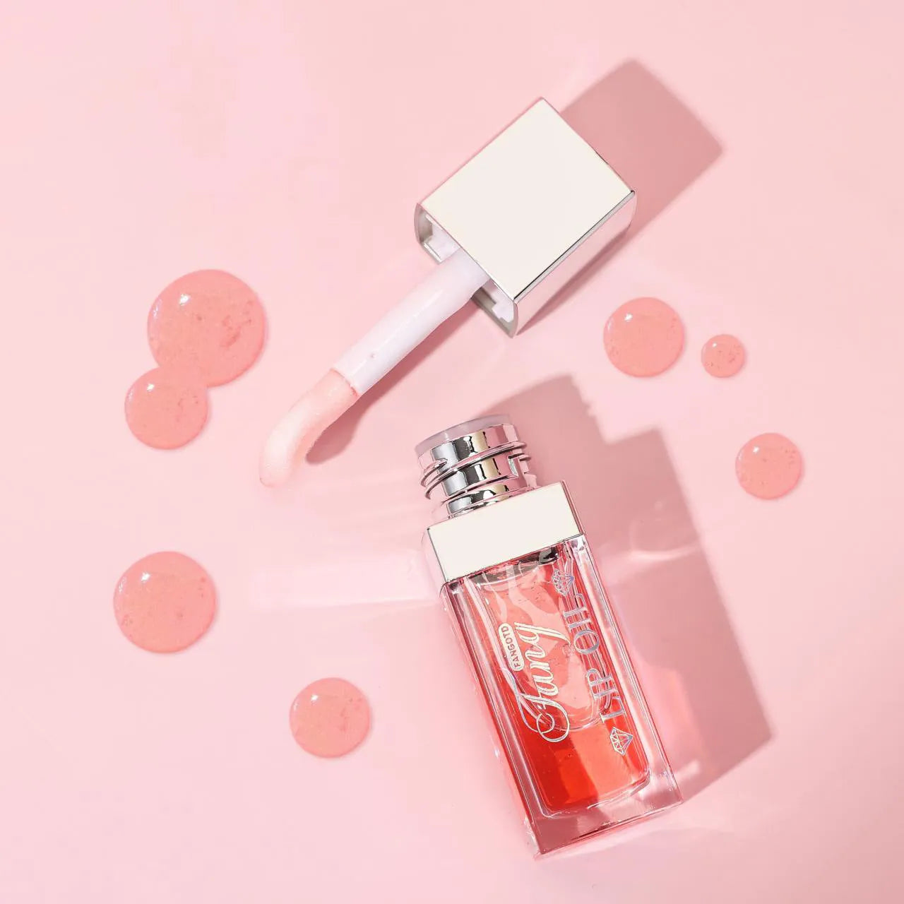 Mint lip gloss tube in one of five colours including bright pink, orange and dark red.