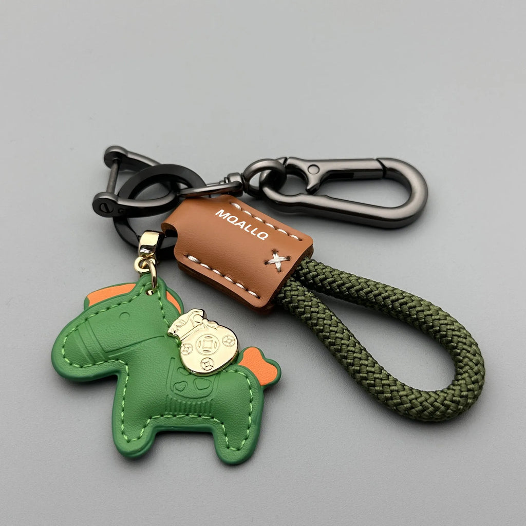 Handmade brown cowhide key pendant with a green flannel rope and a gold-toned horse-shaped buckle.
