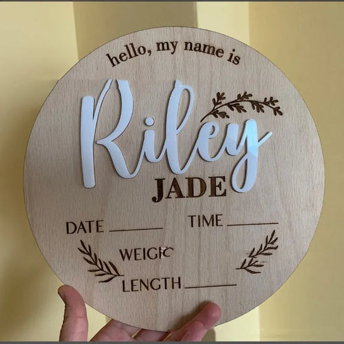 Square wooden baby name sign with birth information, 15 cm wide, in one of three style variants.