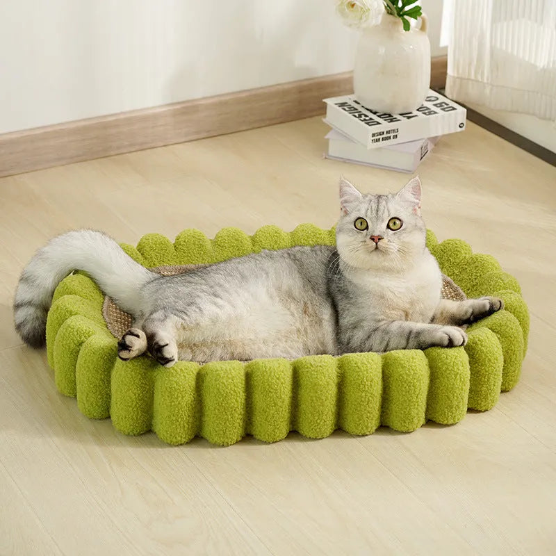 Green oval cat scratching pad with sisal surface measuring 65cm long, functioning as both scratcher and lounger bed