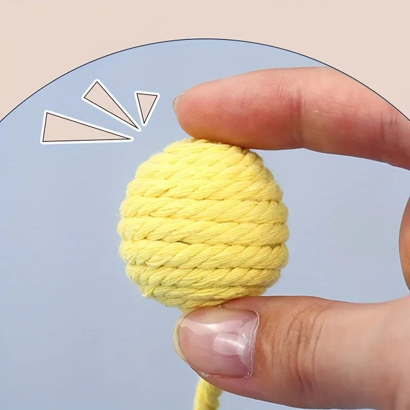 Cat toy ball with attached rope and bell in green, pink, purple or yellow colours showing 6cm and 3cm size comparison