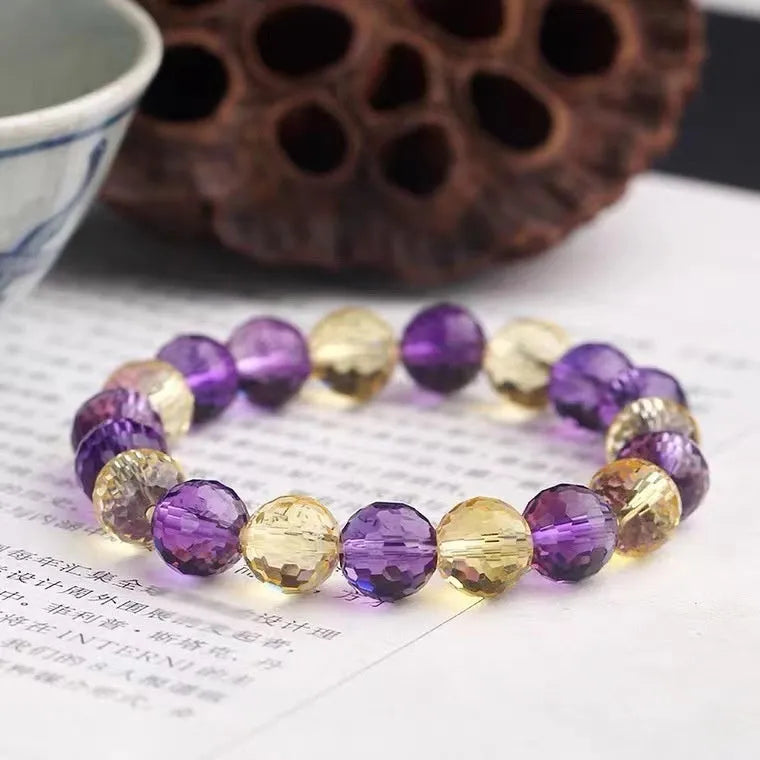 Close-up of a 128-facet cut crystal ametrine bracelet with detailed bead modelling on a wrist.