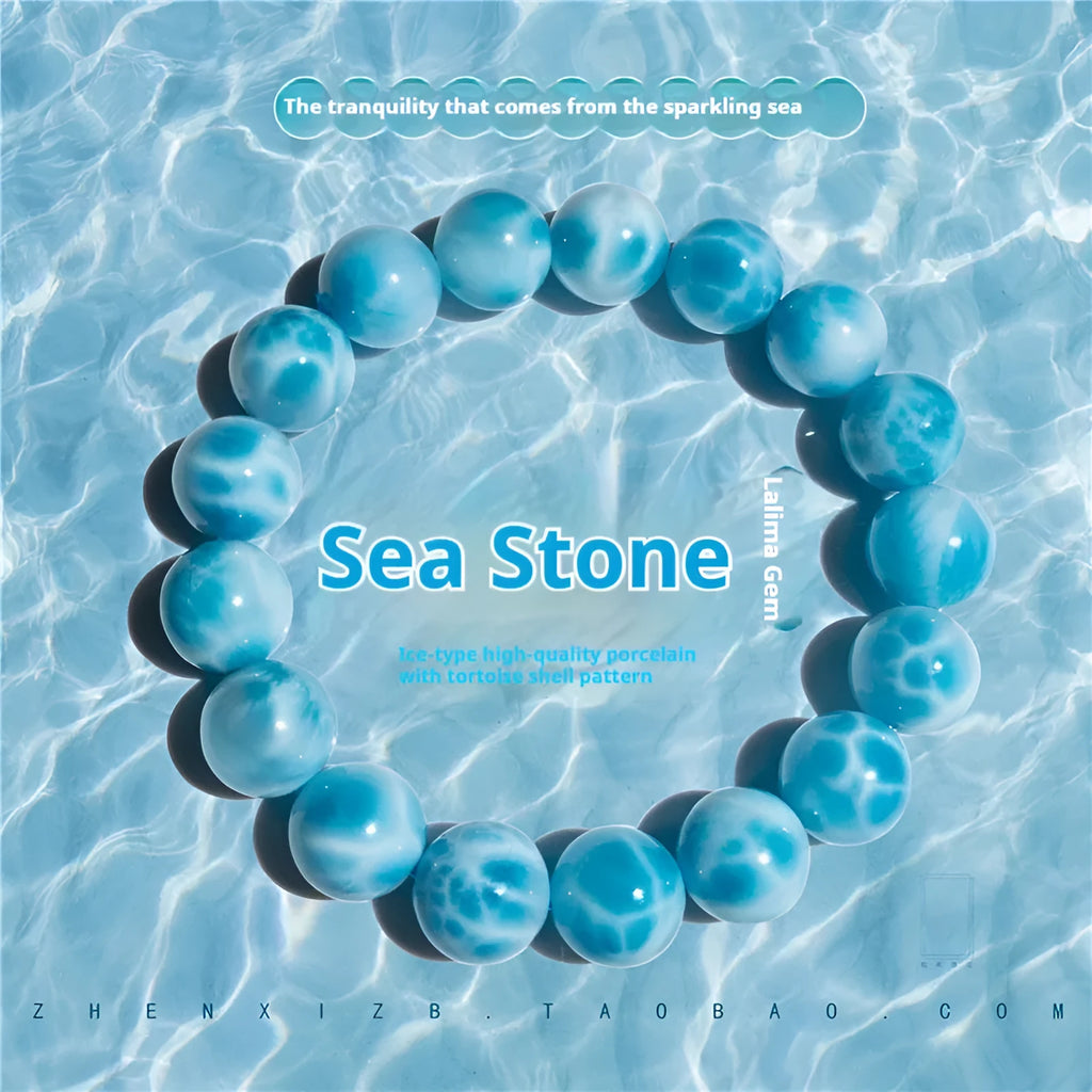 Blue Bodhi bead bracelet with a natural crystal sea-pattern stone charm on a wrist.