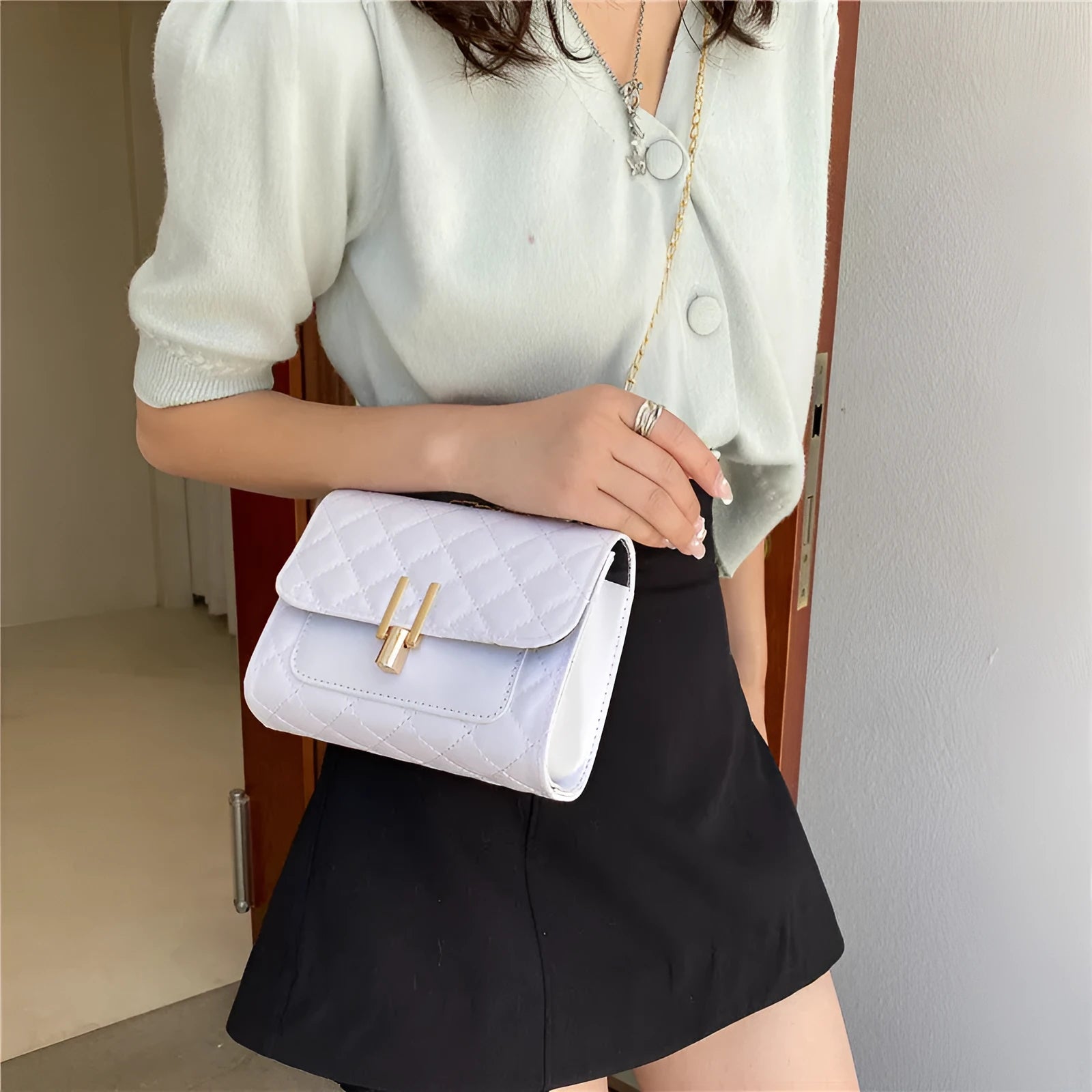 Women's white PU crossbody bag with diamond lattice texture and adjustable chain shoulder strap