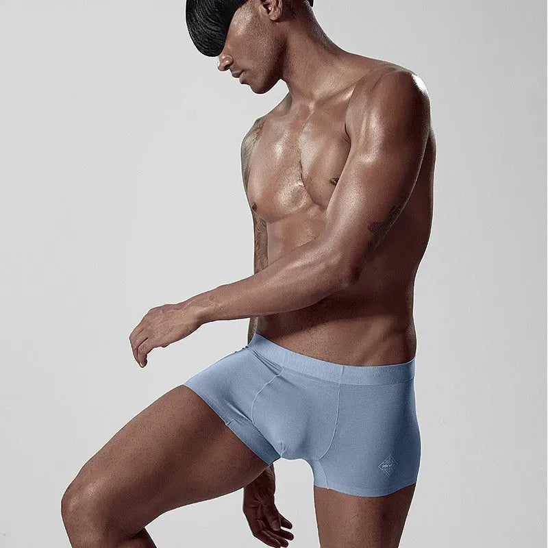 Men's seamless one-piece modal underwear in green on a mid-waist mannequin.