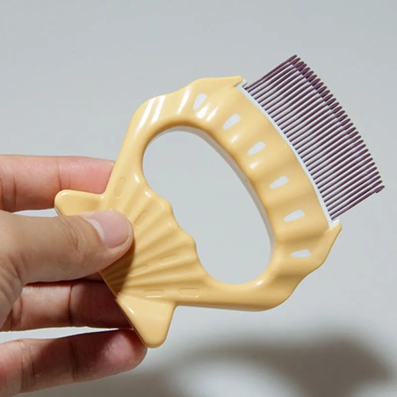 Green shell-shaped plastic pet grooming comb with bent wire bristles and an anti-slip handle.