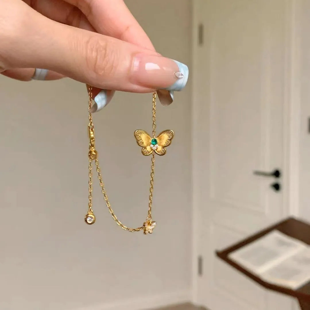 Gold copper hollow butterfly bracelet with wire drawing finish on display