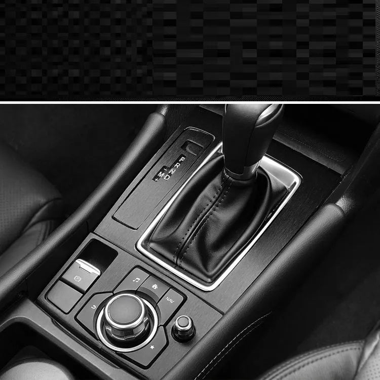 Car interior decorative film sticker kit showing carbon fibre pattern applied to centre console and dashboard