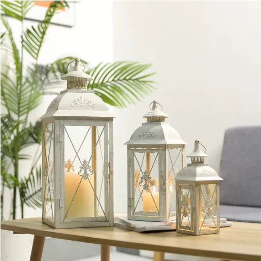 Black and white wrought iron floor-standing storm lantern with tempered glass in three sizes for courtyard use.