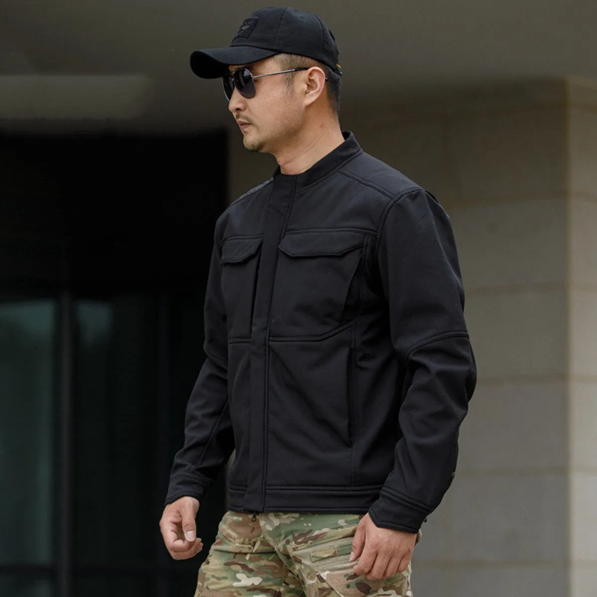 Bone Frog Peak Breaker soft shell tactical jacket in black, shown in outdoor setting.