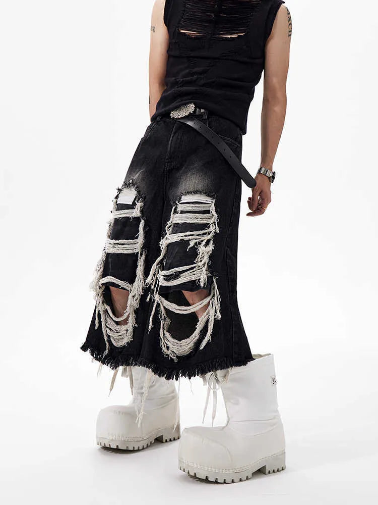 Black cropped wide leg jeans with mid-high waist and ripped patch detail on a loose fit.